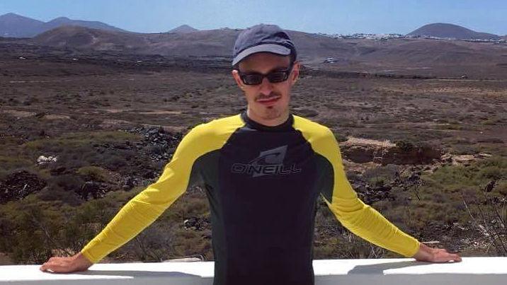 Lewis in Lanzarote with the hills behind him.