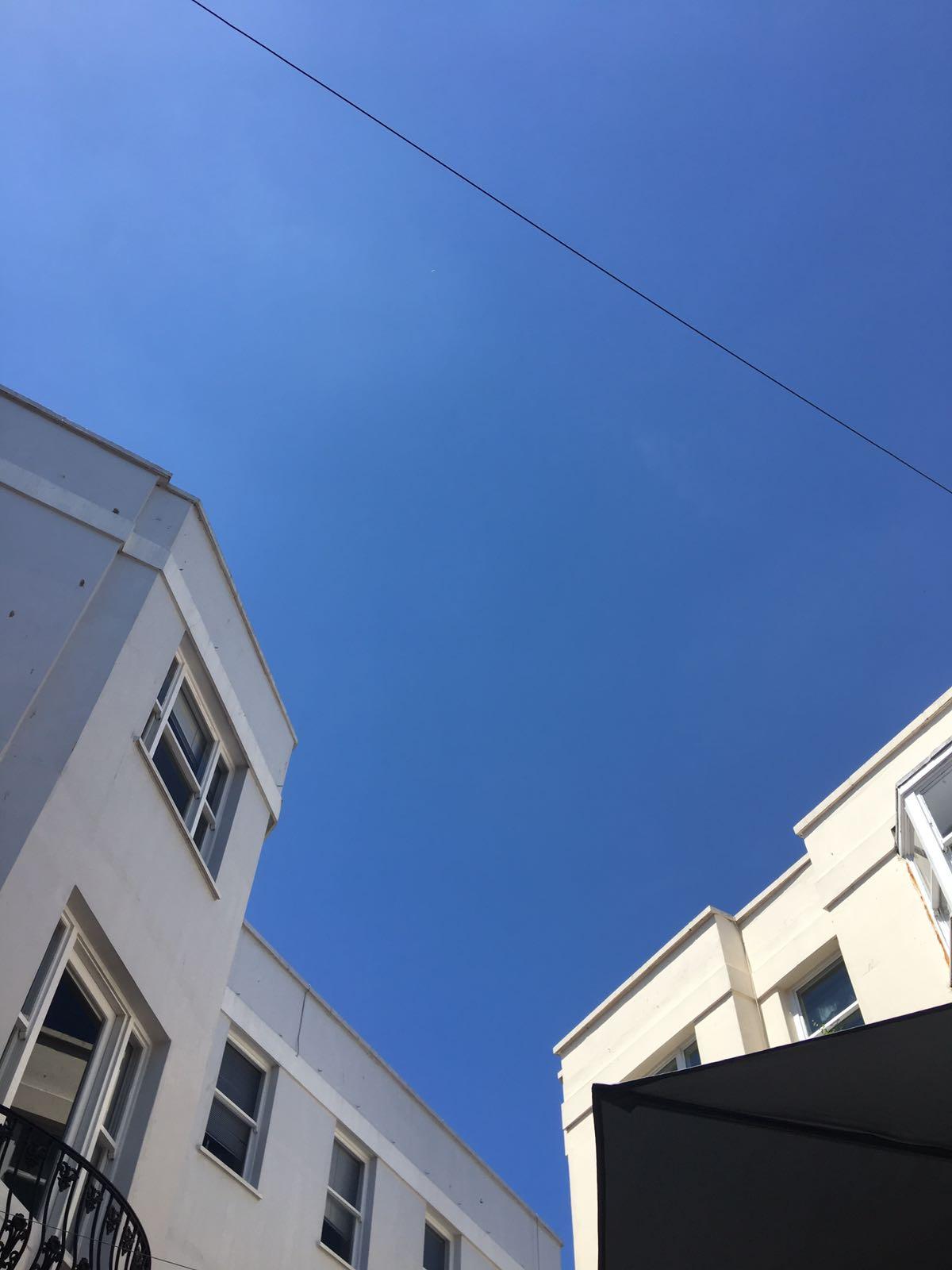 Blue sky over white houses.