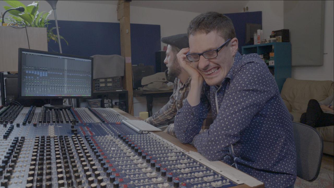 Lewis laughing at the mixing desk.