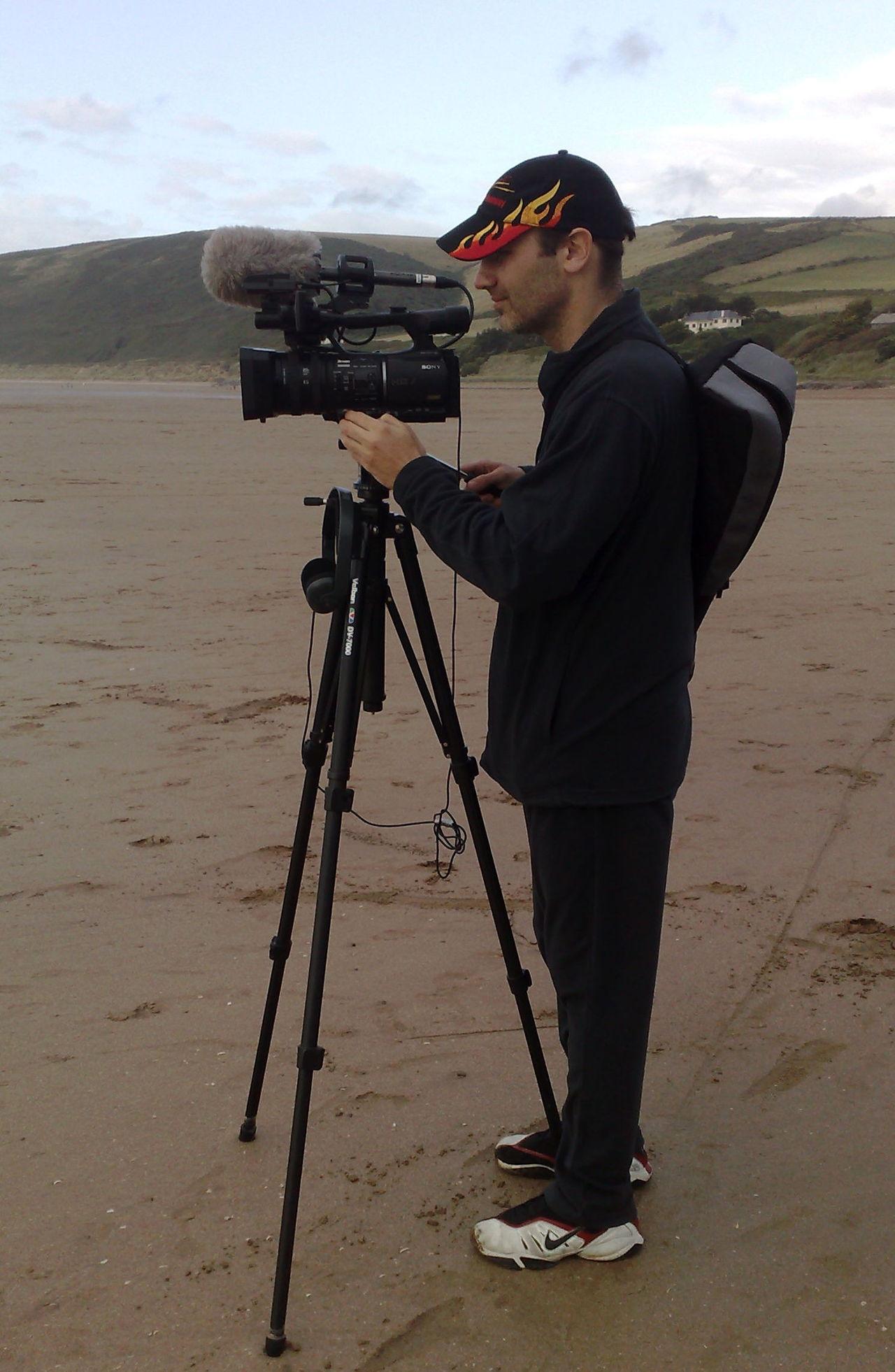 Dan filming on the beach.