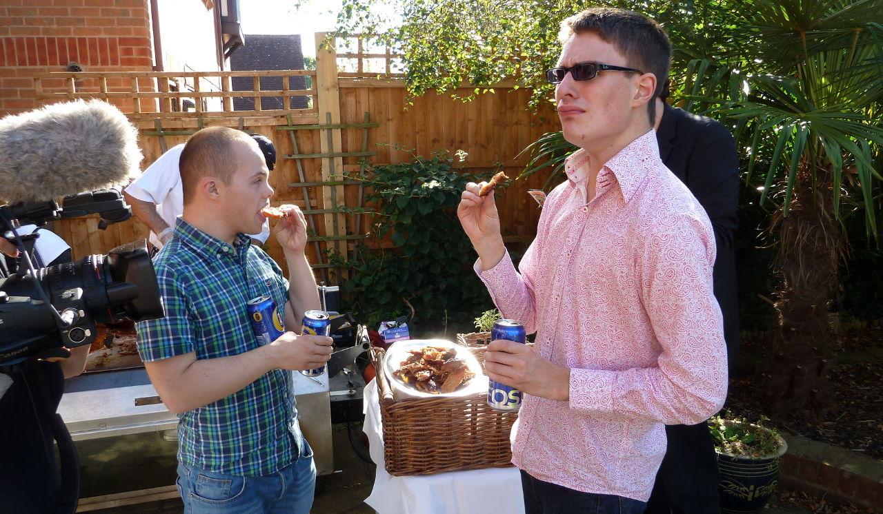 Lewis and Sam at a BBQ ignoring the camera.