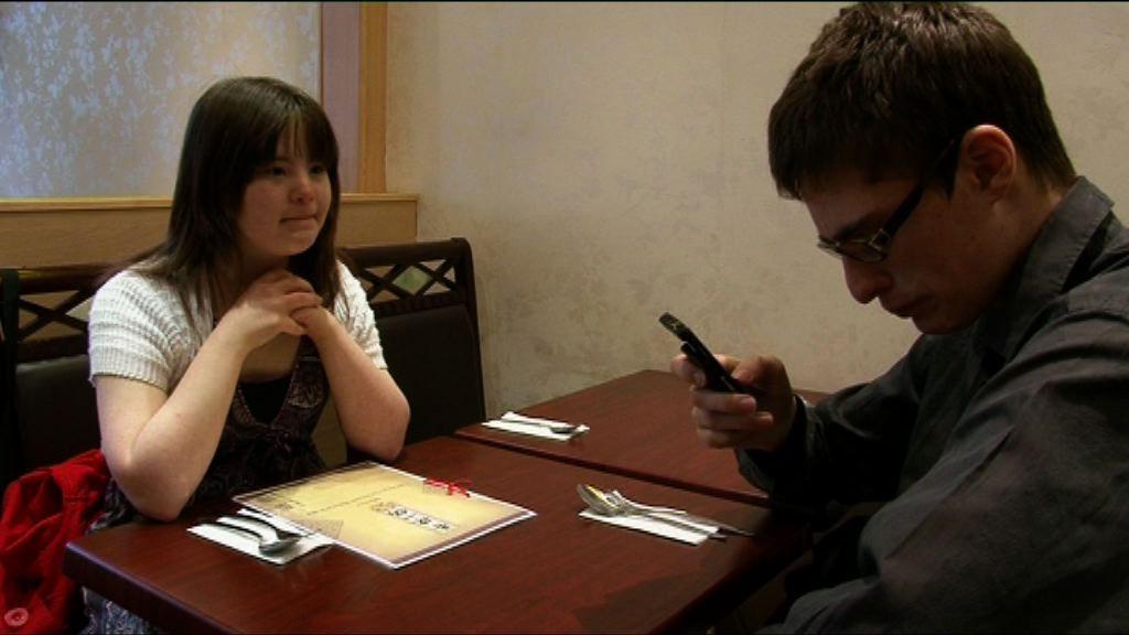 Megan and Lewis sitting at a table in a restaurant.