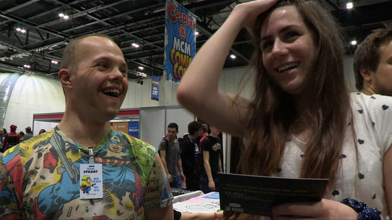 Sam in super heros T-shirt with girl at Comic Con.